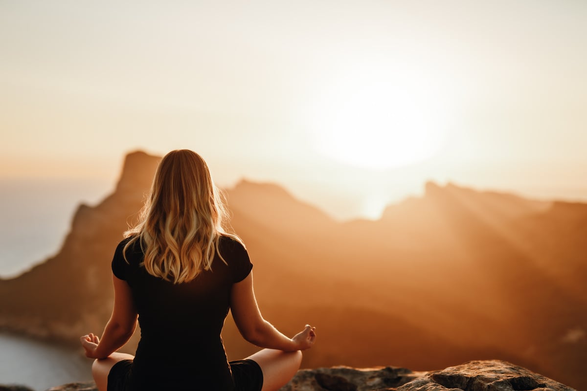 Meditating girl in the mountains